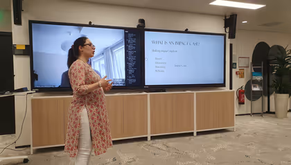 woman who is presenting in front of a screen