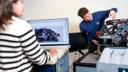 Collaboration on advanced mechanical setup in lab, highlighting precision engineering and innovation in high-tech systems and materials.