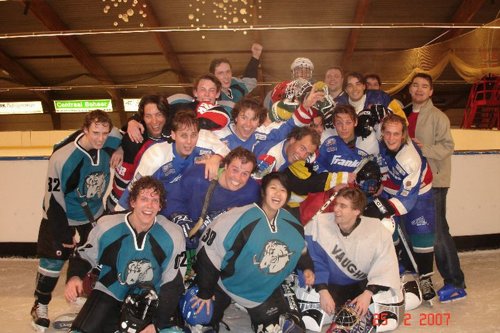 Wing Yan in front of her Slapping Studs icehockey team